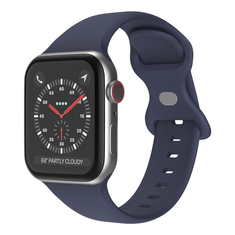 Navy silicone butterfly buckle Apple Watch band shown attached to a watch