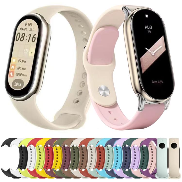 Silicone smart band straps in assorted colors, shown with two fitness trackers