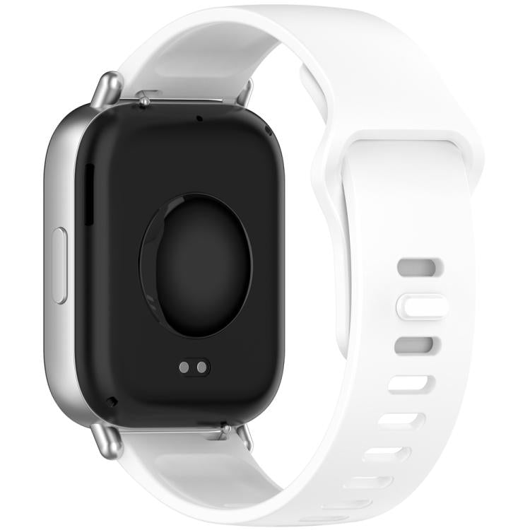 White silicone watch band attached to a smartwatch, shown from the back with adjustment holes.