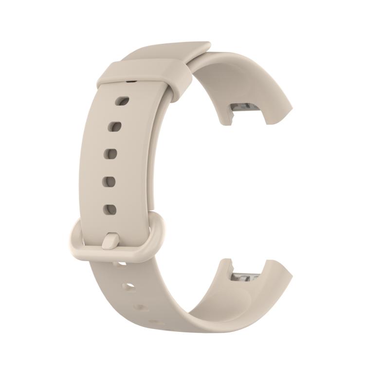Ivory silicone watch band with adjustment holes and a matching buckle.