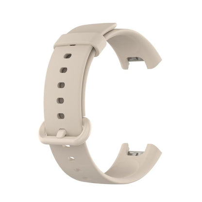 Ivory silicone watch band with adjustment holes and a matching buckle.