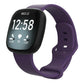 Fitbit smartwatch with a dark purple silicone band and adjustable buckle