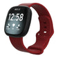 Dark red silicone watch band fitted to a black smartwatch, with adjustable buckle and pin holes