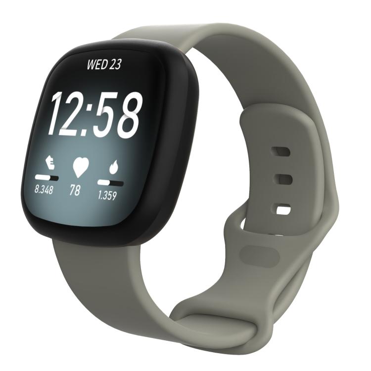 Gray silicone watch band fitted on a Fitbit smartwatch