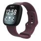 Burgundy silicone watch band fitted on a Fitbit smartwatch