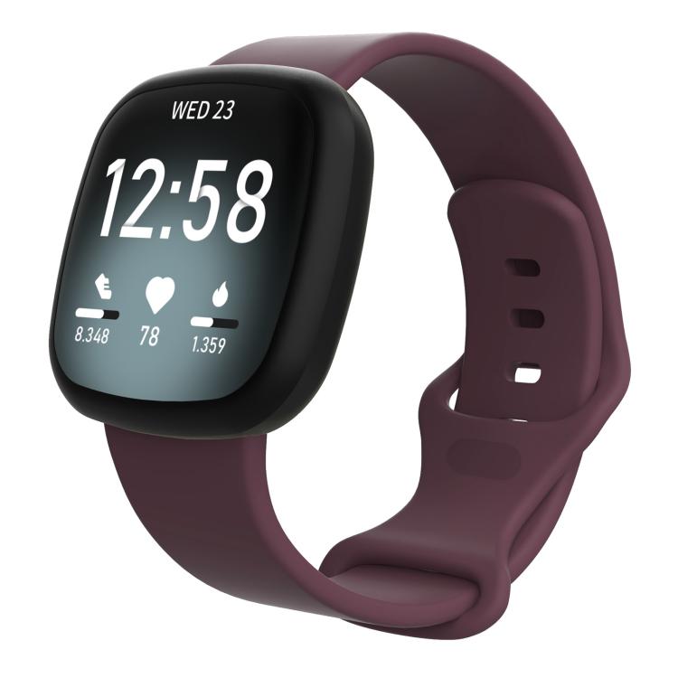 Burgundy silicone watch band fitted on a Fitbit smartwatch