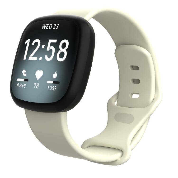 Cream silicone watch band on a smartwatch, showing the strap and adjustment holes