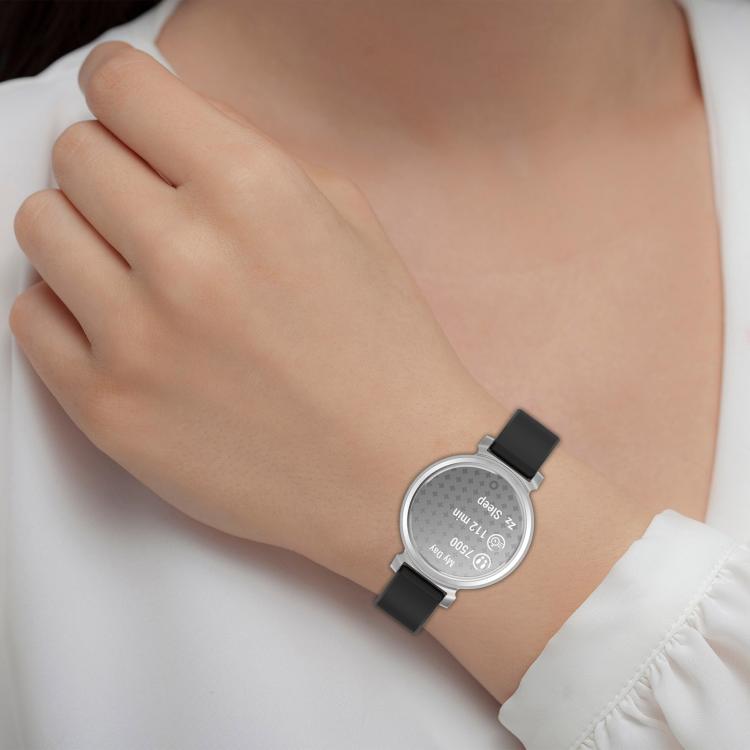 Black silicone watch band worn on the wrist with a silver round smartwatch.