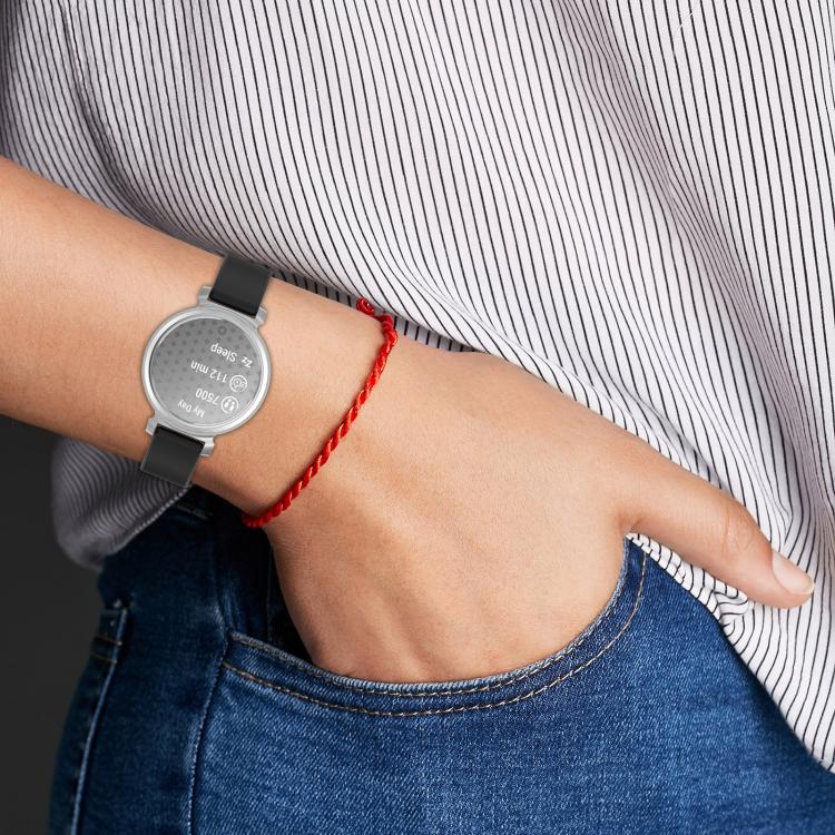 Black silicone watch band worn with a silver round smartwatch.