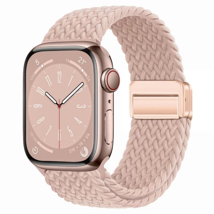 Pink sand woven watch band with a matching magnetic clasp on a rose gold watch