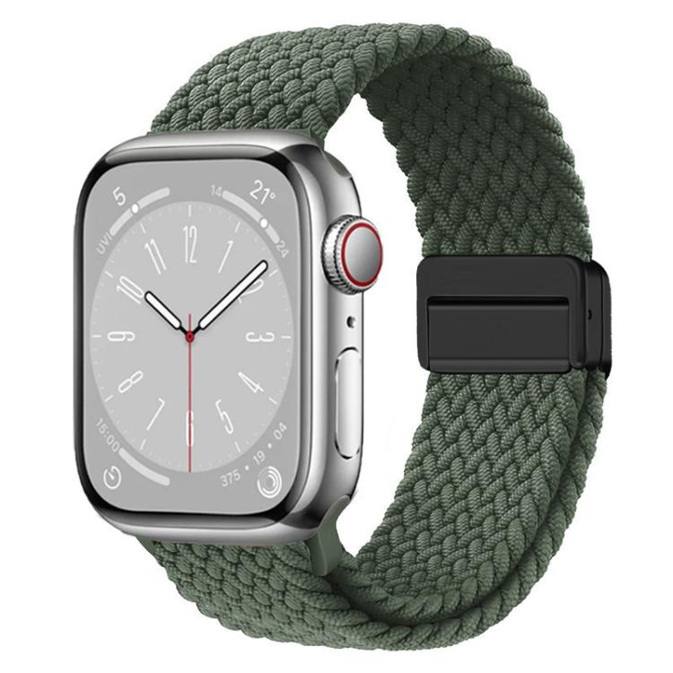 Green woven watch band with a black magnetic clasp on a silver watch