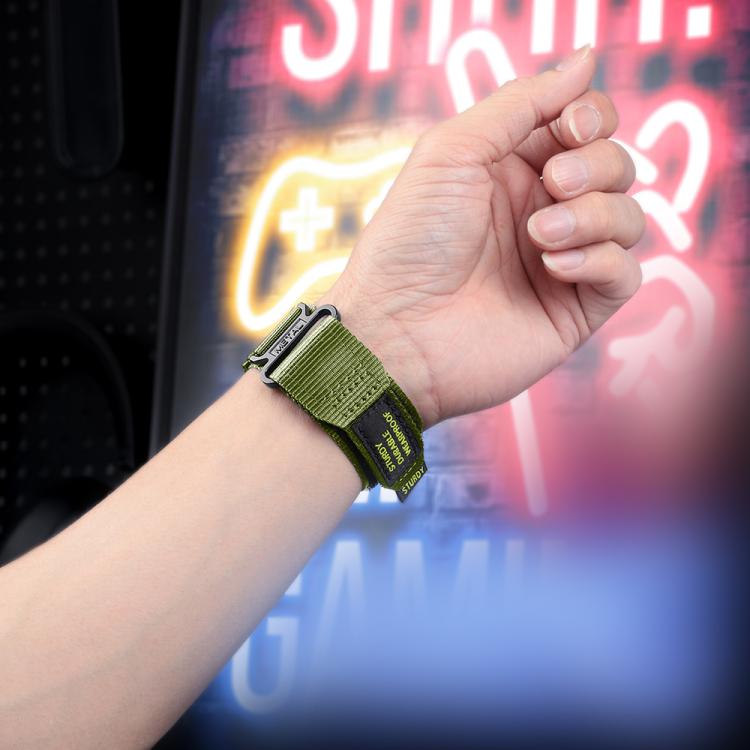 Green nylon watch band with hook-and-loop closure worn on a wrist