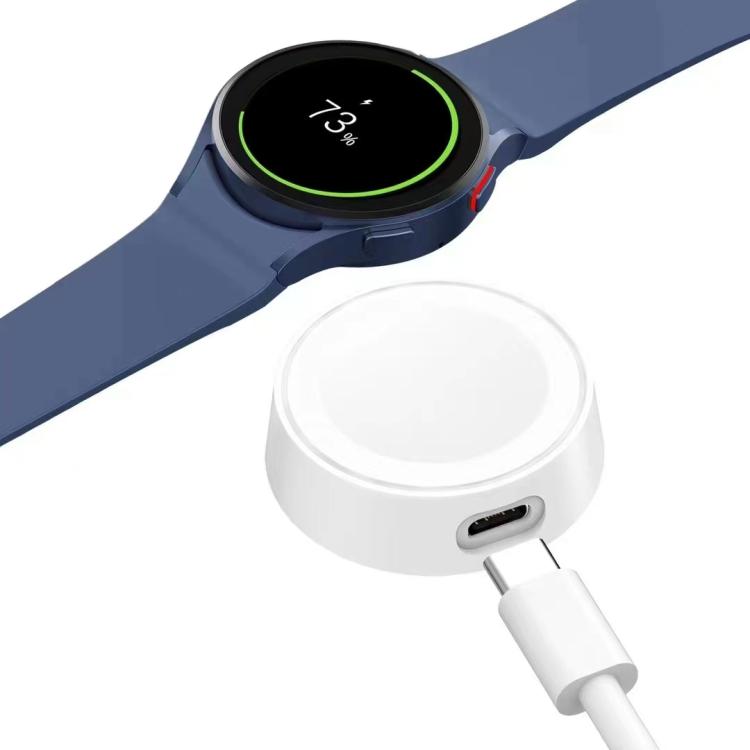 White xDfind magnetic smartwatch charger with cable beside a charging smartwatch