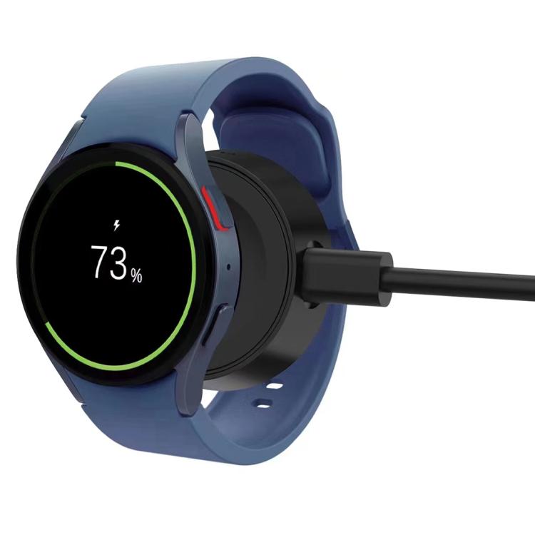 Black magnetic smartwatch charger attached to the back of a smartwatch