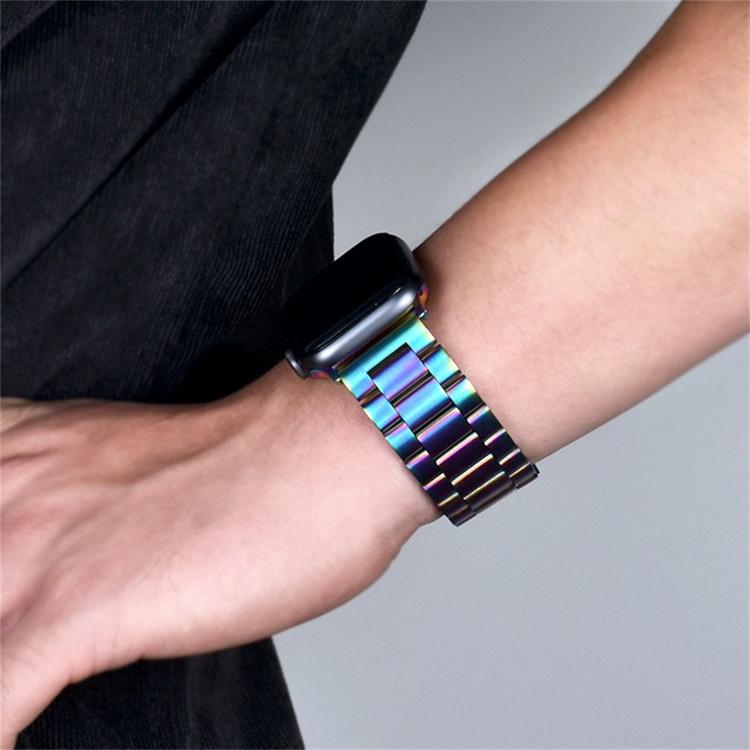 Iridescent stainless steel watch band with linked beads, worn on the wrist