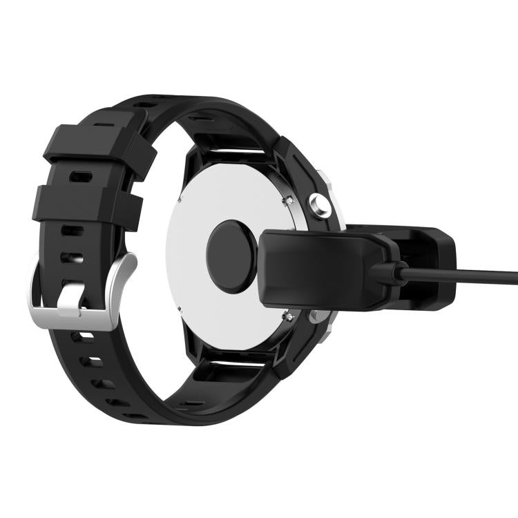 Clip charger attached to the back of a Garmin MARQ ATHLETE Gen1 watch