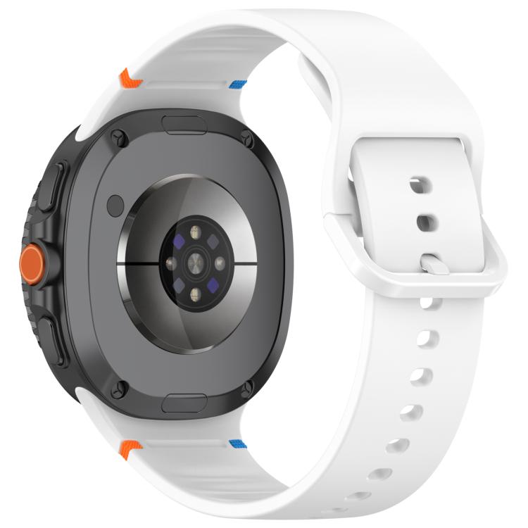 White silicone watch band fitted to a smartwatch, shown from the back with its buckle.