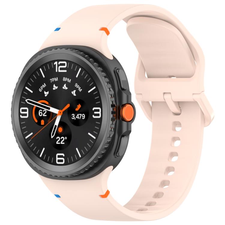 Pale pink silicone watch band with adjustable holes and buckle on a black smartwatch.