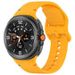 Orange silicone watch band with buckle and adjustment holes, shown fitted to a smartwatch.
