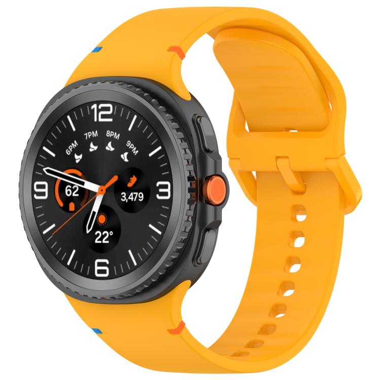 Orange silicone watch band with buckle and adjustment holes, shown fitted to a smartwatch.