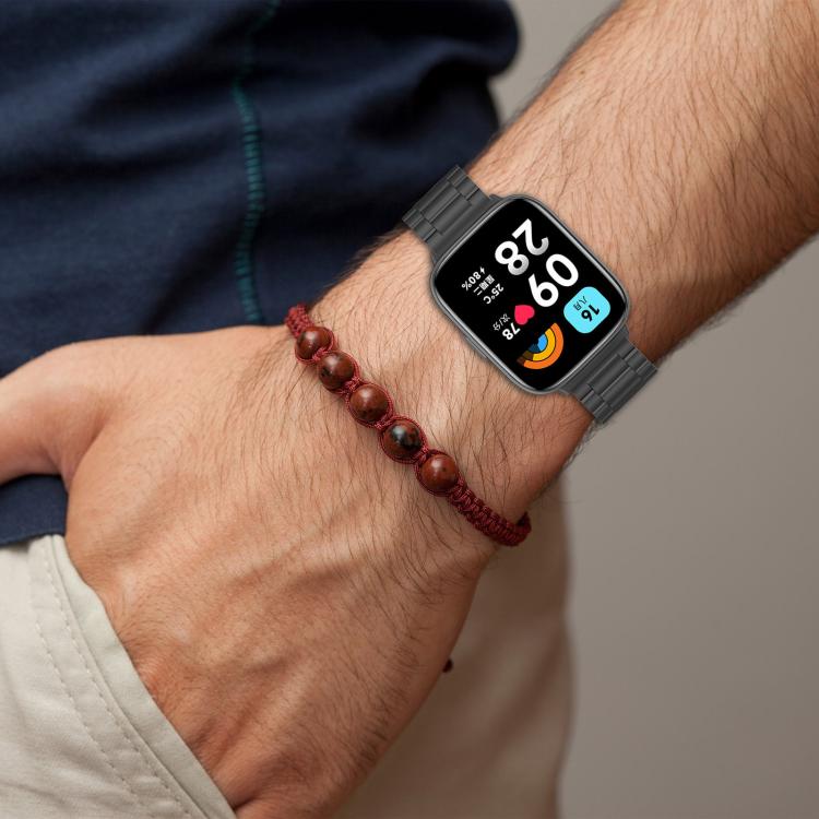 Black metal watch band worn on a wrist