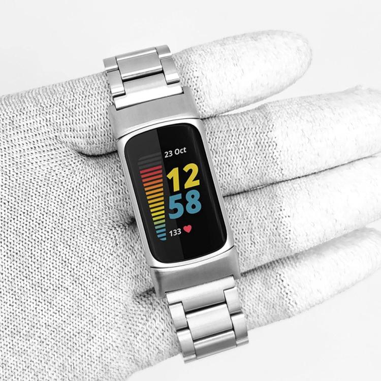 Silver three-bead metal watch band attached to a fitness tracker.