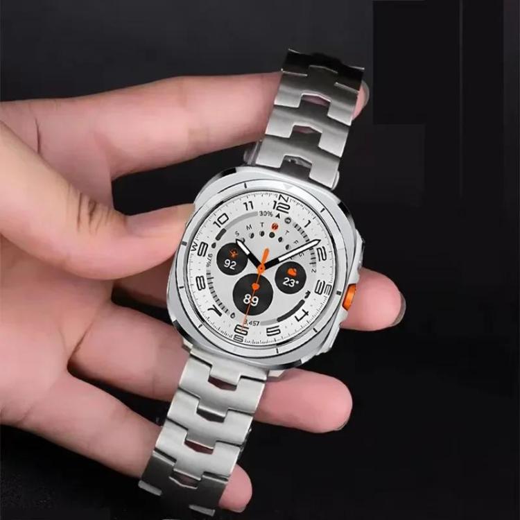 Silver titanium alloy watch band with linked bracelet, attached to a smartwatch and held in hand