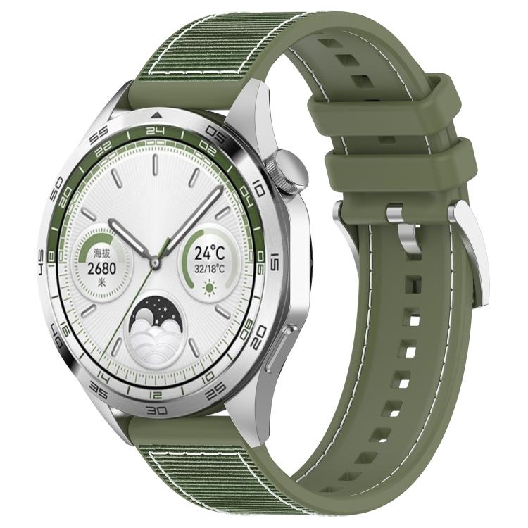 Green hybrid nylon and silicone watch band with stitched panels and adjustable holes, shown on a watch.