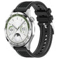 Black hybrid nylon and silicone watch band with stitched panels and adjustable holes, shown on a watch.
