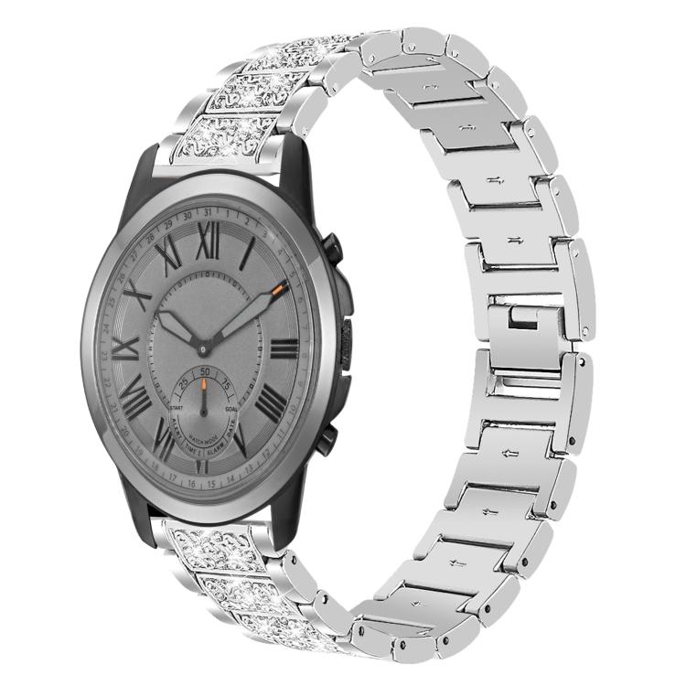 Silver stainless steel watch band with sparkling stone-set links, shown on a silver-dial watch.