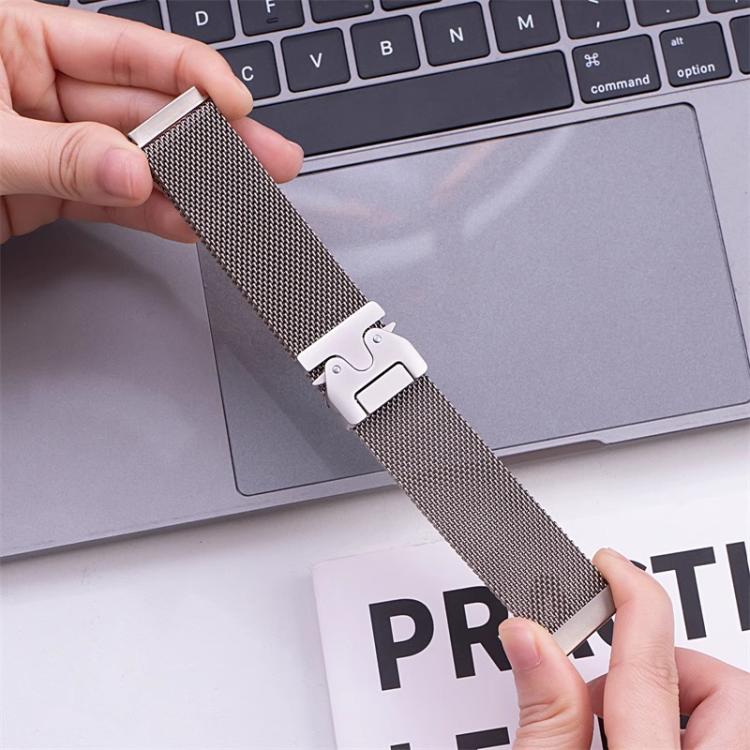 Silver mesh watch band with raised clasp held in both hands