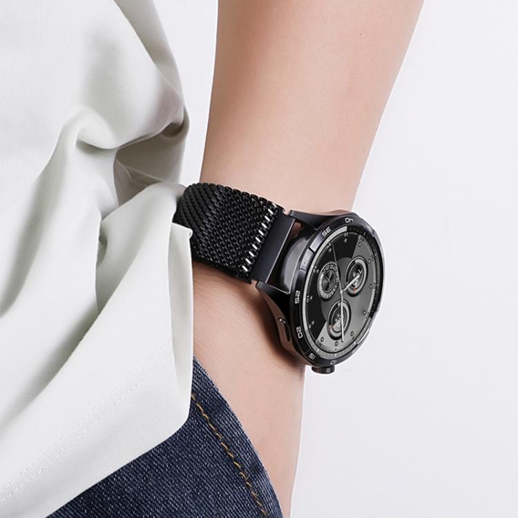 Black mesh watch band worn on a wrist with a black smartwatch