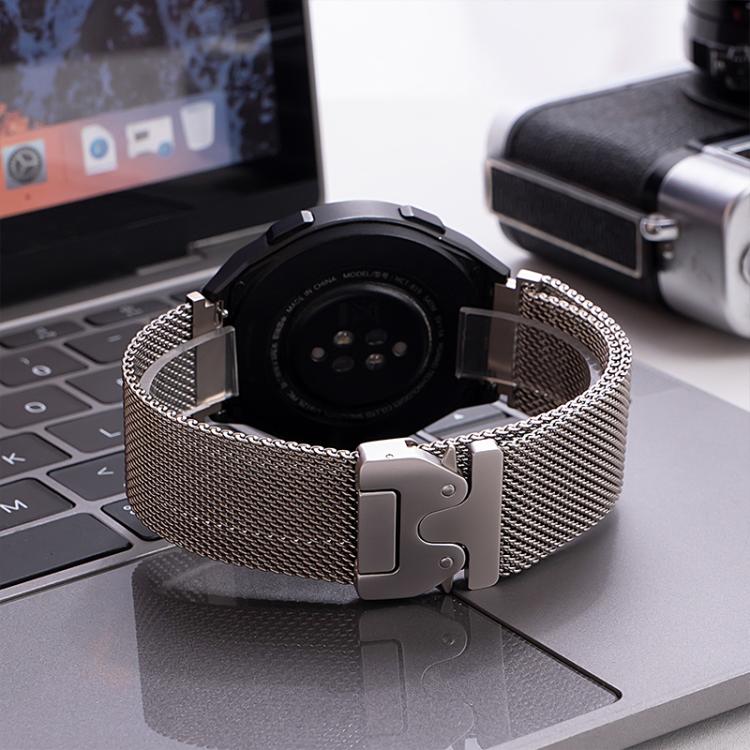 Silver mesh watch band with raised clasp attached to a smartwatch