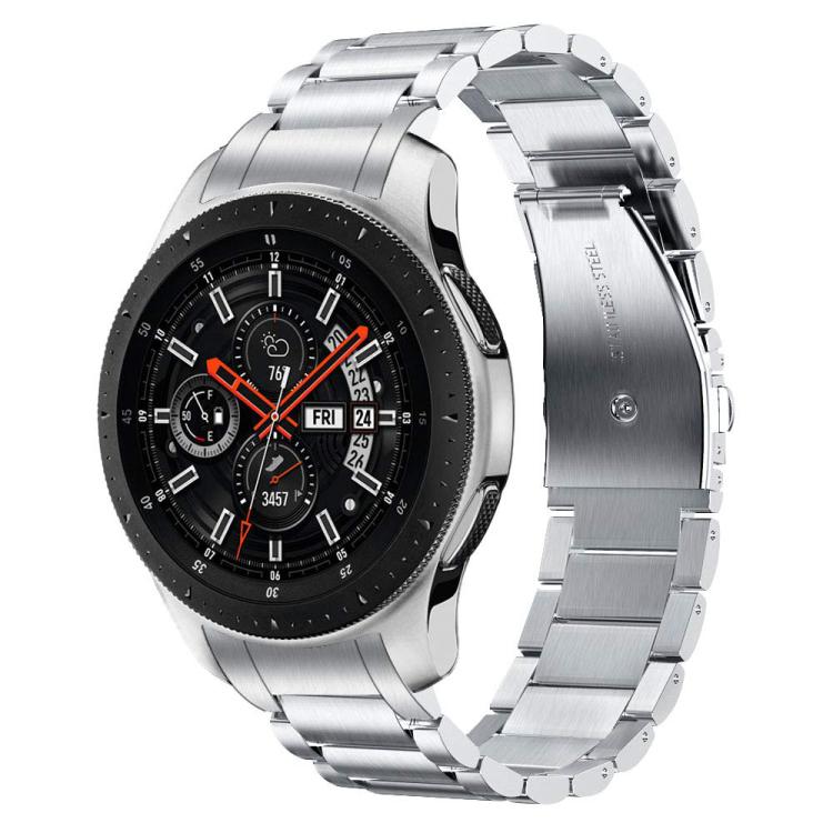 Silver three-link watch band with folding clasp, shown attached to a watch.