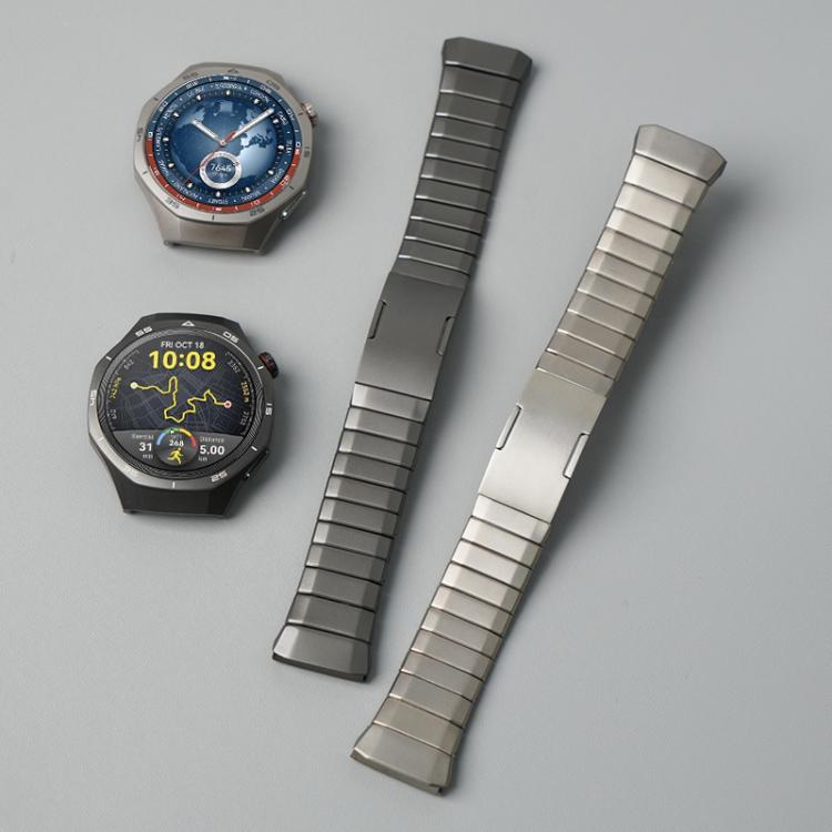 Two segmented titanium alloy watch bands in dark gray and silver, shown beside compatible watches.