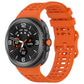 Orange perforated silicone watch band with a dark Galaxy smartwatch attached