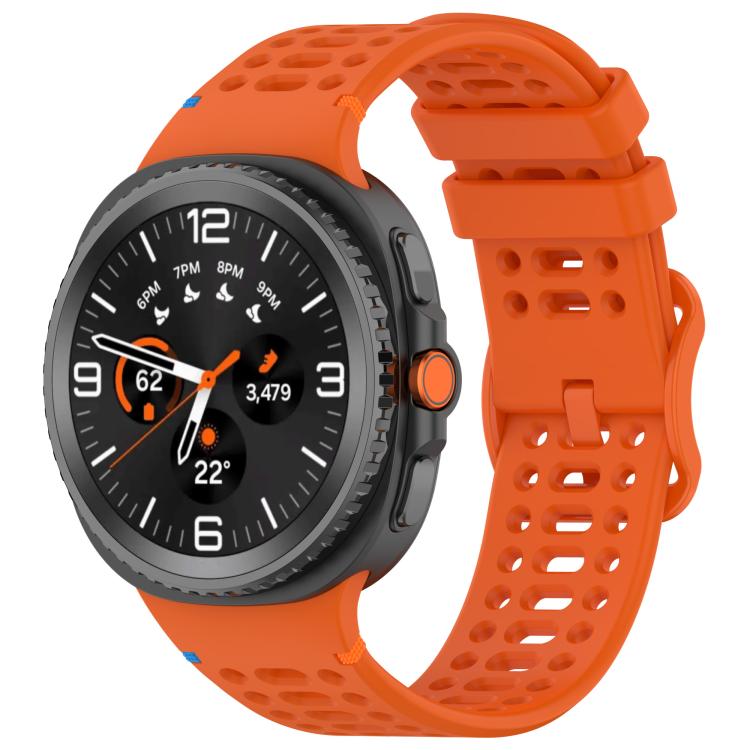 Orange perforated silicone watch band with a dark Galaxy smartwatch attached