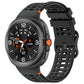 Black perforated silicone watch band with a dark Galaxy smartwatch attached