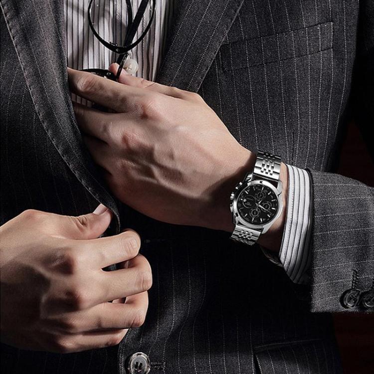 Silver seven-bead stainless steel watch band worn on a wrist