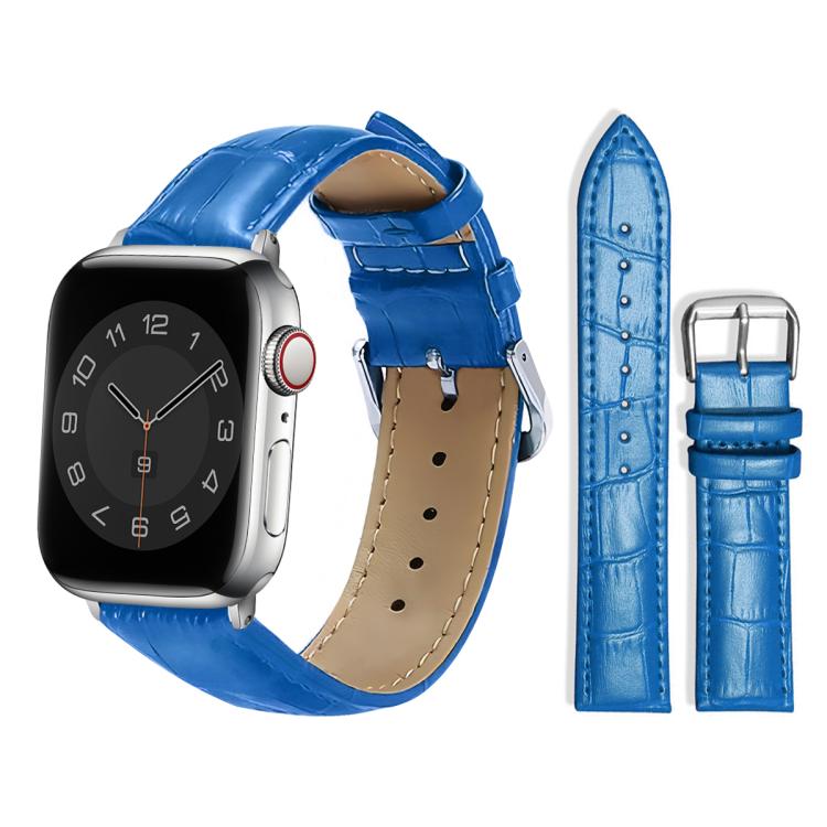 Blue leather watch strap with raised texture, adjustment holes, and a silver pin buckle.