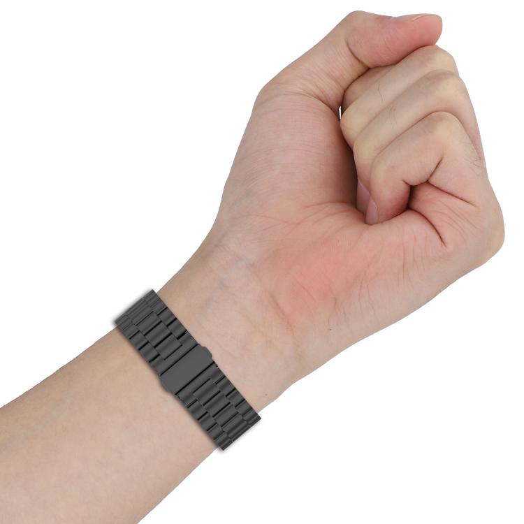 Black titanium alloy watch band with linked tri-bead design worn on wrist