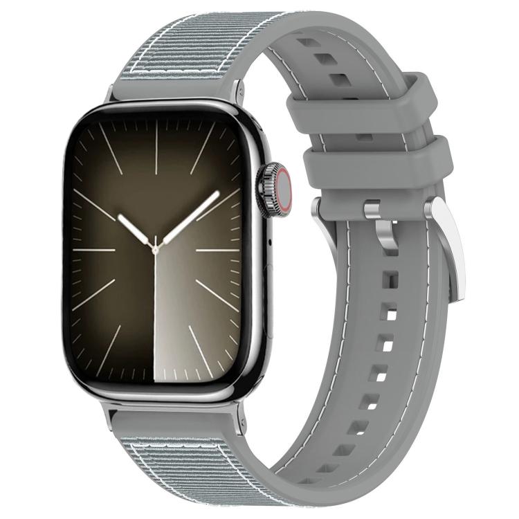 Gray hybrid watch band with woven nylon panels, perforated silicone strap, and metal buckle, on a watch