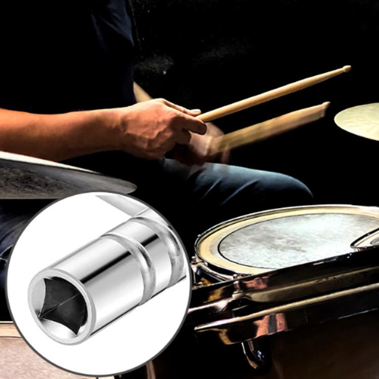 Drum tuning key with square socket near snare hardware and tom components
