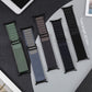 Five nylon watch bands in green, blue-gray, brown, navy and black, shown flat