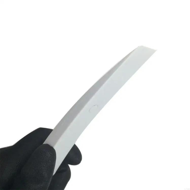 White trim removal tool tip held by black-gloved hand for prying