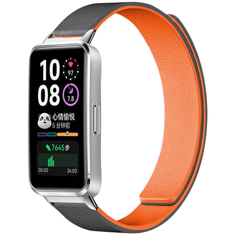 Magnetic silicone watch band with black exterior and bright orange lining, shown attached to a smartwatch.
