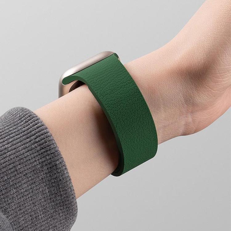 Dark green litchi-texture silicone watch band worn on a wrist