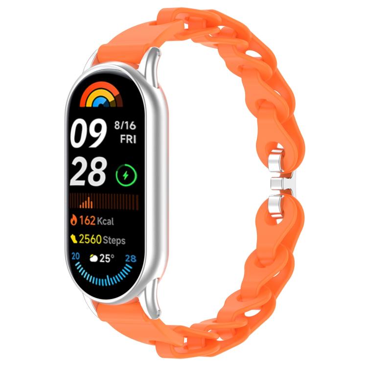 Orange hollow-link silicone watch band fitted to a smartwatch.