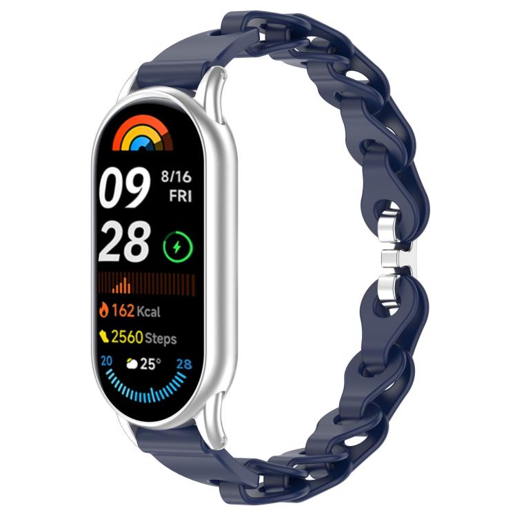 Dark navy hollow-link silicone watch band fitted to a smartwatch.