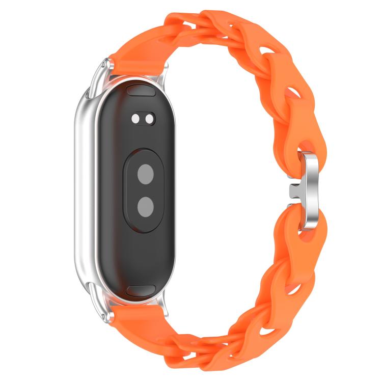 Orange hollow silicone watch band shown fitted to the back of a smart band